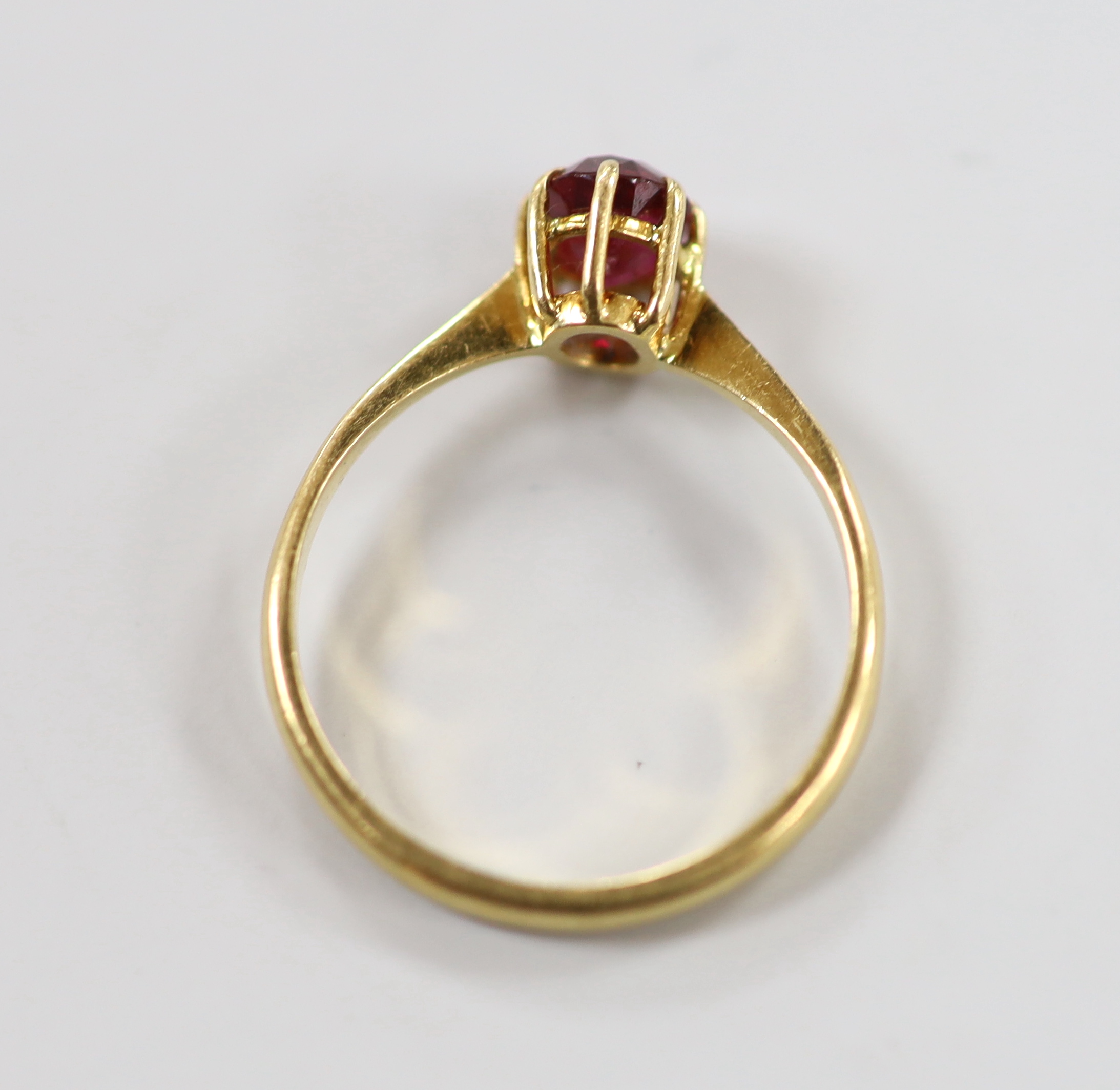 A 1960's 18ct gold and solitaire ruby set ring, size O, gross weight 2.2 grams.